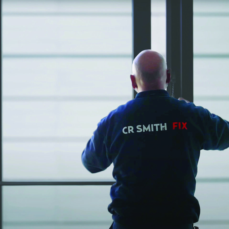FIX staff member operating a large window in a hotel